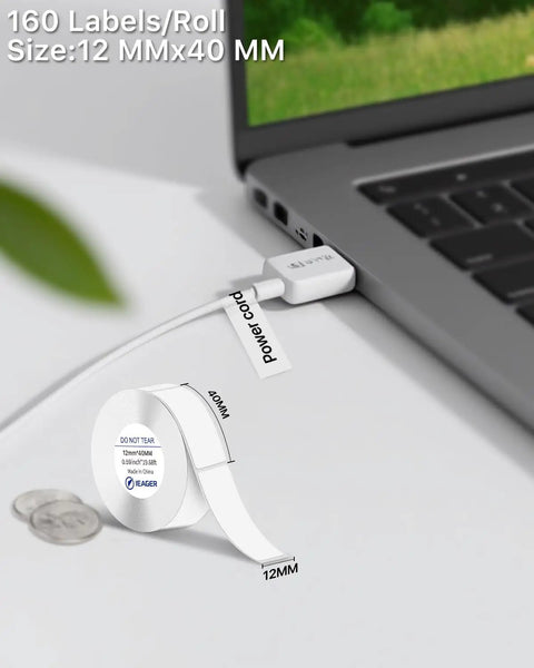 Top Tier Thermal Label Maker Tape 12mm By 40mm Legit Strong Grip White Refill Rolls 160 Labels Each Roll on a laptop with power cable.