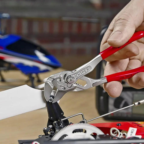 Hand using All-In-One Adjustable Pliers Wrench Set For Inch And Metric Nuts And Bolts With Smooth Non-Marring Jaws Chrome-Safe Finish