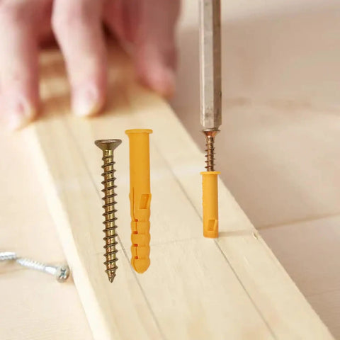 Built Like A Tank 50 Piece Concrete Drywall Anchor Set With Rock Solid Plastic Expansion Sleeves And Razor Sharp Self Tapping Flat Head Screws Drop Dead Easy To Mount, showcasing yellow plastic plugs and metal screws.