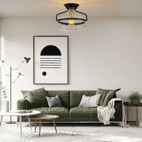 Room with Seeded Glass Semi Flush Mount Ceiling Light In Matte Black, 11.2 Inch Shade, above green sofa and modern decor.