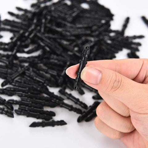 Hand holding 150 Pieces One Quarter Inch Straight Barbed Irrigation Connectors Fittings For Drip System Garden Tubing