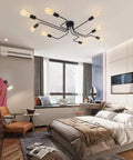 Eight Light Sputnik Ceiling Fixture In Matte Black Cool Industrial Chandelier Semi Flush Mount installed in a modern bedroom