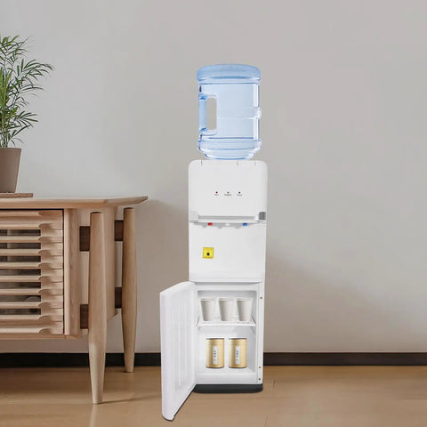 Top Loading Water Cooler For 5 Gallon Bottles With Hot Cold And Warm Water Three Temperature Options And Child Safety Lock Quiet Home Office Dispenser Durable White Construction For Everyday Use next to wooden cabinet.