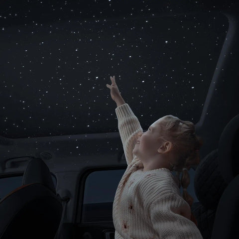 Child enjoying Starry Sky Car Projector And Diffuser With Air Freshener, Ceiling Ambient Light.