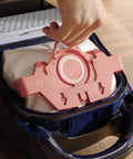 Hand inserting HyClean Air FJM Vacuum Bags for Compact C1 and C2 Canisters, showing easy bag change mechanism.