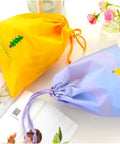 Waterproof Drawstring Storage Bags Set Of Five Made From PE Plastic Great For Travel Gym Swim Gear And Laundry Organization Quick Access And Easy Packing For Home Or On The Go, yellow and purple bags displayed on table