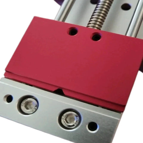 Close-up of Solid Mini Bench Vise With Dual Shape Jaw for clamping PCB Phone Motherboards and cylindrical components on CNC drill presses.