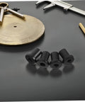 Four black barn door spacers on gray surface, part of Heavy Duty Carbon Steel Barn Door Clamps And Sliding Door Replacement Spacers Set.