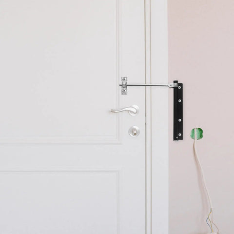 Stainless Steel Door Closer Spring For Doors And Gates, Automatic Silent Close installed on a white door in a home setting