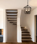 4 Light Lantern Pendant Light With Industrial Black Cage Farmhouse Chandelier in modern staircase setting