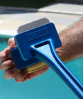 Person holding Bristle Free Grill Scraper Head Replaceable Cleaning Tool For Cast Iron And Stainless Steel Grates Safe Durable BBQ Cleaner 2 In 1 Grate Scraper No Bristles No Worries Easy To Replace near a pool.