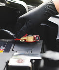 Gloved hand installing Beefy Brass Battery Terminal Connectors Kit, 1 Pair With M8 x 25mm Bolt on car battery post