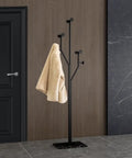 Heavy-Duty Freestanding Coat Rack With Tree-Shaped Metal Design And Marble Base in hallway, holding a coat, black, 68.9 inches tall