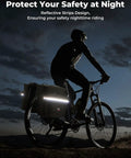 Cyclist with 34L Waterproof Bike Pannier Bag With Rain Cover For Rear Rack in low light, reflective strips visible, ensuring safety.
