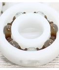 Close up of Premium Pom Plastic Ball Bearings 5 Piece Kit showcasing the smooth inner and outer surfaces for precision use.