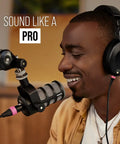 Person using PodMic Cardioid Dynamic Broadcast Microphone with XLR output for studio podcasts and live streaming, not USB plug in.