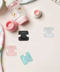 Four Pack Easy Install Refrigerator Door Locks for Childproofing, shown in various colors, on a table with baby items