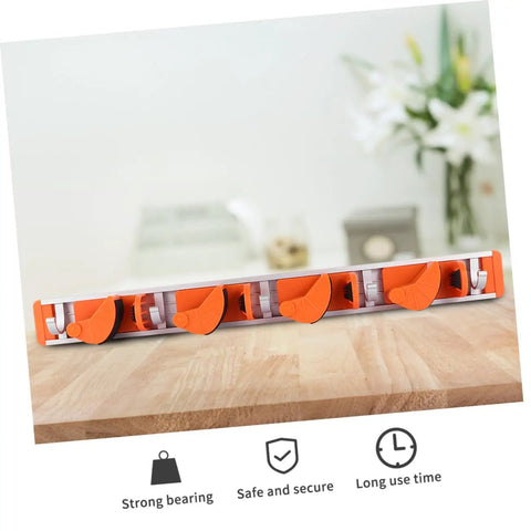 Wall Mounted Broom Holder With Heavy Duty Aluminum Hooks And Sturdy Abs Mounts For Garage Gear Storage and Hassle Free Cleanup Station Easy Install Mop Organizer Shelf Rack System on a wooden surface.