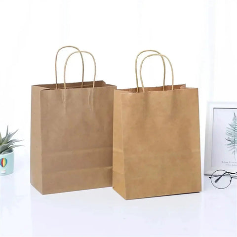 Two bulk kraft paper gift bags with handles on a white surface; Bulk Kraft Paper Gift Bags 30 60 150 Pack Recyclable Party Favor Bags.