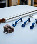 Quiet Roller Cabinet Catch 12 Pack Set for Cabinets and Furniture Doors with copper tone metal shell on table