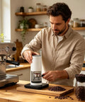 Smooth Operator Electric Coffee Tamper With 5 To 30 Kg Adjustable Pressure and Smart LCD Touch Screen in kitchen, user preparing espresso.