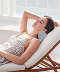 Woman relaxing on chair with Ergonomic Neck Pillow For Recliners And Couches, Memory Foam Headrest Cushion, gray and white