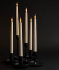 24 Pack 11 Inch LED Flameless Ivory Taper Candles With Flicker Battery Operated Long Tall Candlesticks on black holders