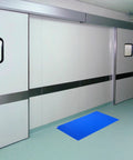Disposable Sticky Adhesive Mats For Shoes And Equipment Wheels Tear Off Dust Catchers in blue color on a cleanroom floor.