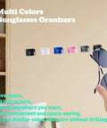 Six Pack Sunglasses And Eyewear Organizer Glasses Holder For Sunglasses And Reading Glasses Space Saving Wall Mount or Desk Rack in Black, multicolor options displayed on wall.