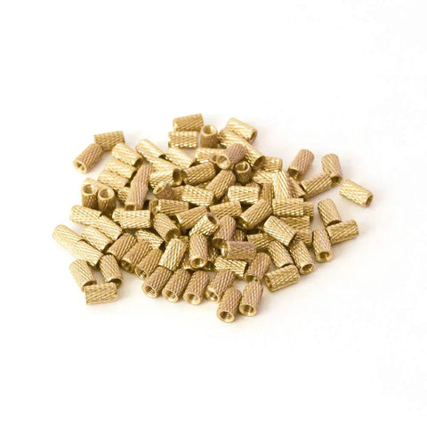 Top Shelf M3 Brass Threaded Inserts For 3D Printing And Injection Molding Bulletproof Press Fit Hardware With Slick Finish bulk pack of small inserts on white background.