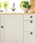 Bee Cabinet Knob Set Solid Four Pack Bumble Bee Insect Drawer Pulls Zinc Alloy Bronze Finish Single Hole Handles for Dresser Cabinet Kitchen and Bath Durable Vintage Style Hardware on white kitchen cabinets.