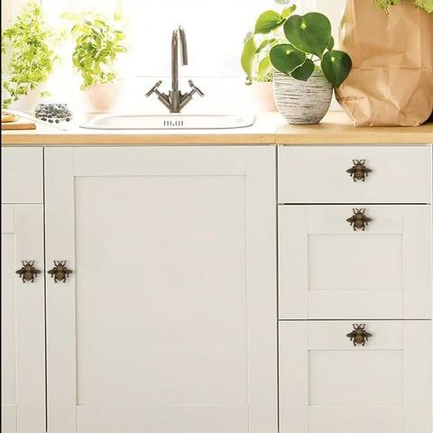 Bee Cabinet Knob Set Solid Four Pack Bumble Bee Insect Drawer Pulls Zinc Alloy Bronze Finish Single Hole Handles for Dresser Cabinet Kitchen and Bath Durable Vintage Style Hardware on white kitchen cabinets.