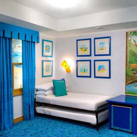 Room with artwork hung using Dope No Damage Picture Hanging Kit With 68 Invisible Nails For Concrete Walls on blue walls.