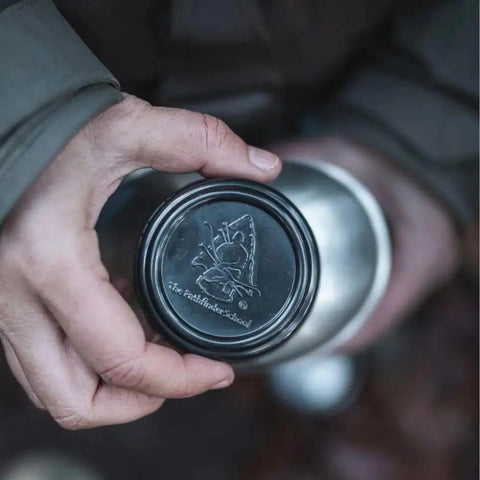 Person holding lid of Stainless Steel Canteen Cooking Set For Survival Camping Nestable Mess Kit Open Fire Ready Military Grade Outdoor Eating Kit