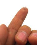 Close-up of a hand holding a tiny screw from the Snag This Game Changing 560 Piece M1 To M1.7 Micro Phillips Pan Head Self Tapping Screw Kit.