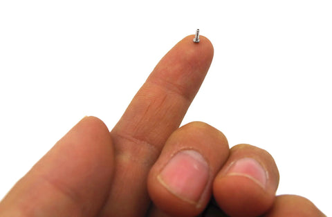 Close-up of a hand holding a tiny screw from the Snag This Game Changing 560 Piece M1 To M1.7 Micro Phillips Pan Head Self Tapping Screw Kit.