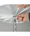 Person assembling the 18 Inch Dual Tier Full Circle Lazy Susan Cabinet Turntable with chrome pole and white trays.