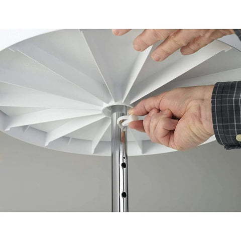 Person assembling the 18 Inch Dual Tier Full Circle Lazy Susan Cabinet Turntable with chrome pole and white trays.