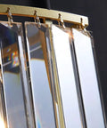 Close-up view of sleek crystal brass wall sconces, showcasing multi-edge crystal strips for major glow in your home.
