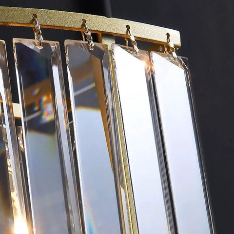 Close-up view of sleek crystal brass wall sconces, showcasing multi-edge crystal strips for major glow in your home.