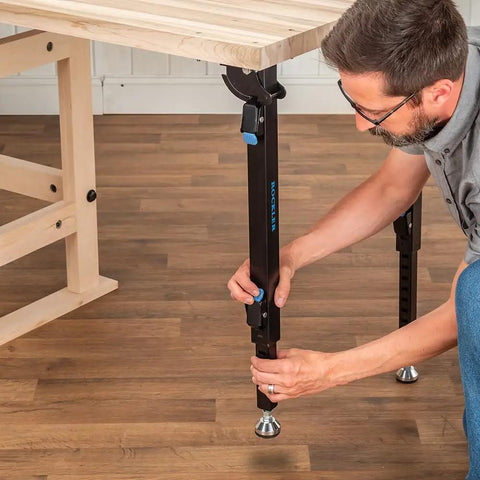 Man adjusting folding leg of Folding Top Extension Kit for Workbench, Space Saving Expansion that Adds a Large, Stable Work Surface