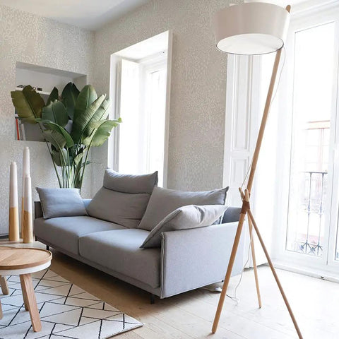 Living room with Whimsical Woodland Fantasy Peel And Stick Wallpaper In Cream And White, grey sofa, and modern lamp.