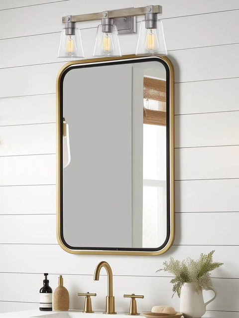 23 Inch 3 Light Farmhouse Vanity Light With Clear Tapered Glass Shades Hand Painted Wood Grain Metal in bathroom setting