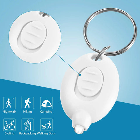 White Mini Keychain LED Flashlight with stainless steel key ring for nurses, displaying button detail. 2.6 inch pocket size.