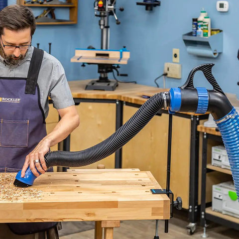 Man using Fence Port Dust Brush For Router Table And Drill Press Cleanup With Flexible Two And Half Inch Hose and Ergonomic Nozzle