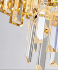 Close-up of Sleek Crystal Ceiling Pendant Light With Modern Designer Shape And Energy Efficient Led Bulbs, showcasing glass prisms.