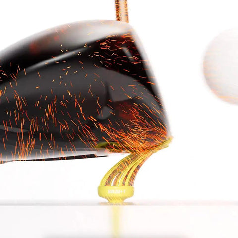 Golf club striking ball from unbreakable yellow plastic tee, sparking effect, showcasing 3 1/8 inch durable design.