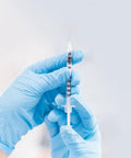 Hands holding 100 Pack 1ml Syringe With 30G 5 By 16 Inch 8mm Needle Individually Wrapped Lab Syringes For Precise Dosing