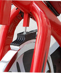 Close-up of installed Four Piece Fitness Bike Brake Pad Set for Exercise Bike Replacement Braking Pads, red frame visible