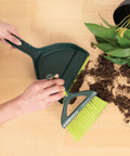 Mini Dustpan And Brush Set With Snap On Nesting Design Compact Portable Handy Broom cleaning up spilled soil and leaves